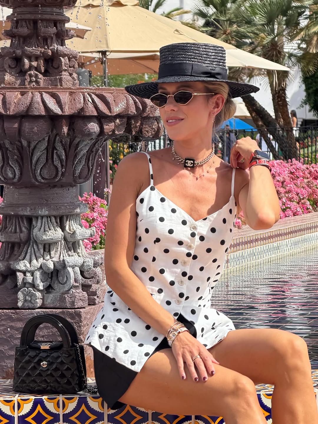 Classic polka dot elegance with a chic boater hat and oversized sunglasses for a